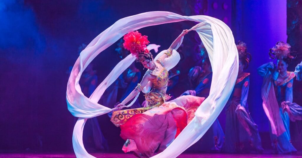 pexels-photo-2736742-2736742 A talented dancer performs a traditional dance with flowing ribbons on a colorful stage.